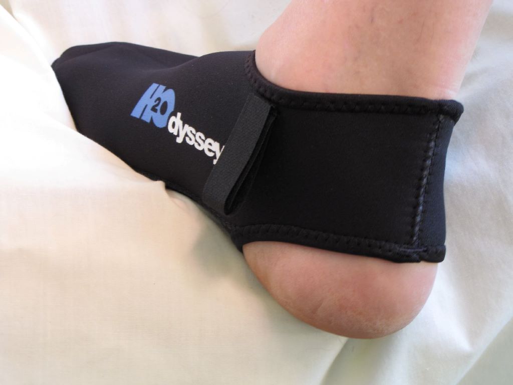Surfer wearing fin socks to prevent blisters and improve comfort in the water