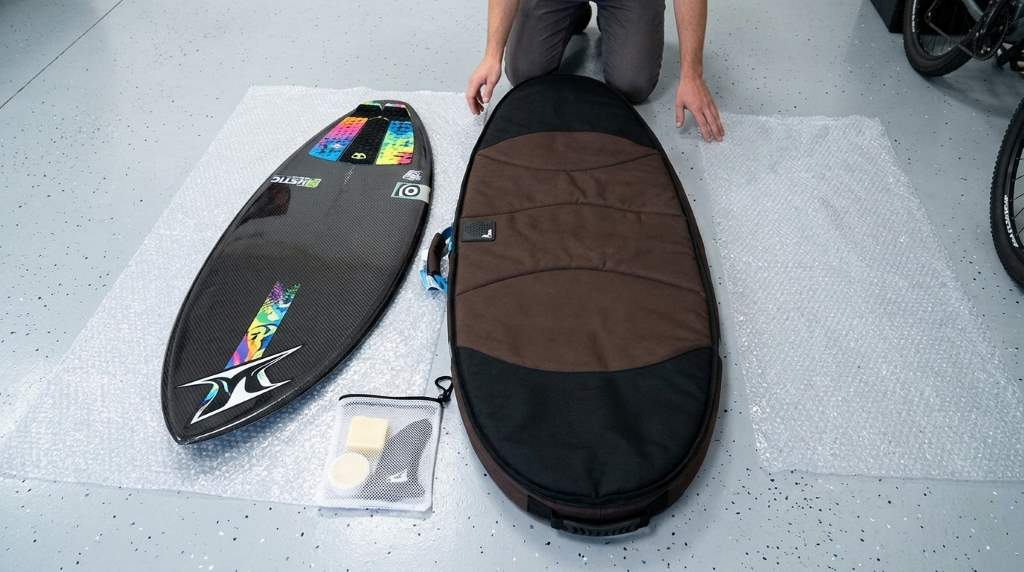 Packed skimboard bag with protective towels and accessories