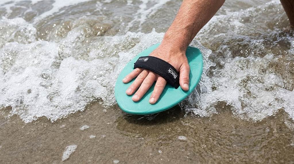 Professional bodysurfer using a handplane on an ocean wave