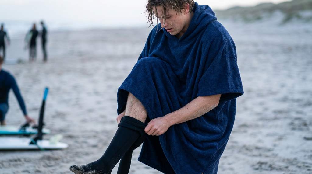 Surfer wearing a surf poncho after a cold water session