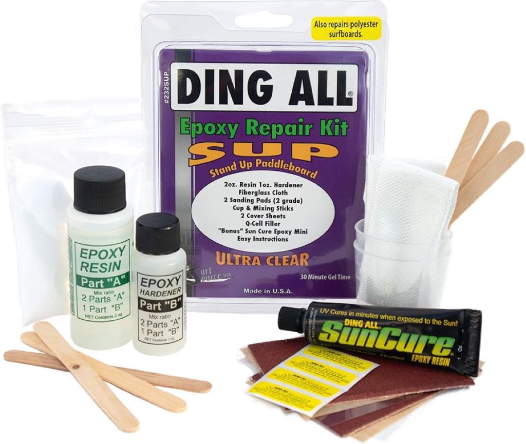 Surfer sanding a damaged surfboard during an at-home repair with a basic repair kit