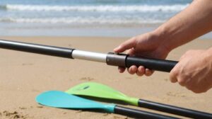 Yvleen adjustable SUP paddle resting against paddleboard on sandy beach